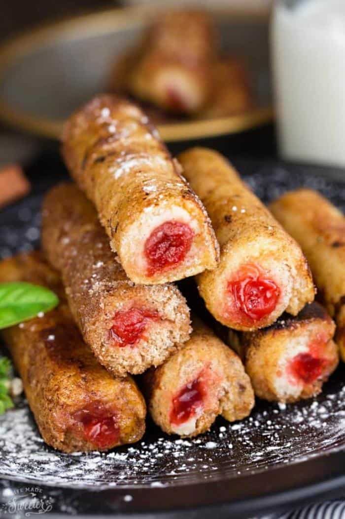 cherry french toast rollups on plate and dusted with powdered sugar