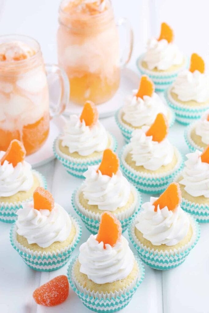 orange creamsicle cupcakes with orange slice candy on top