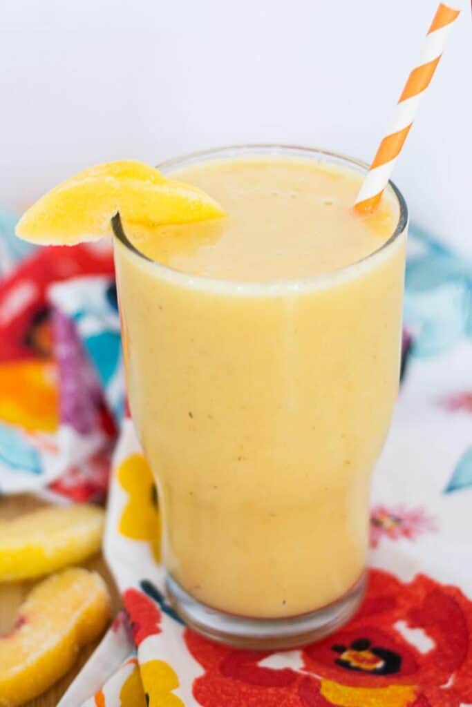 creamy peach smoothie in tall glass