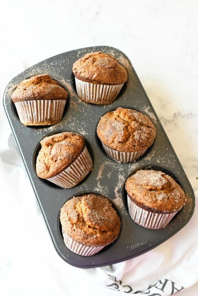 6 jumbo pumpkin muffins in a muffin tin